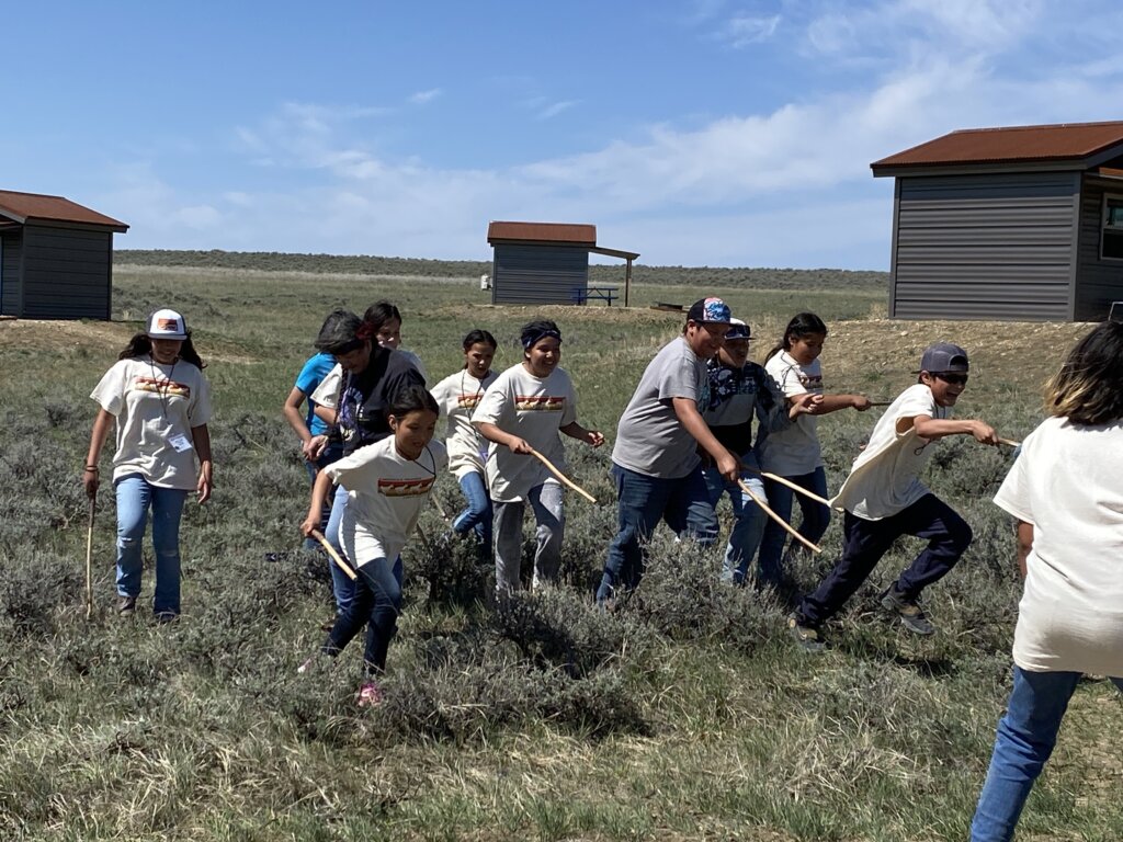 Students enjoy experiential learning and try their hands at traditional Indigenous games at American Prairie's Field School.